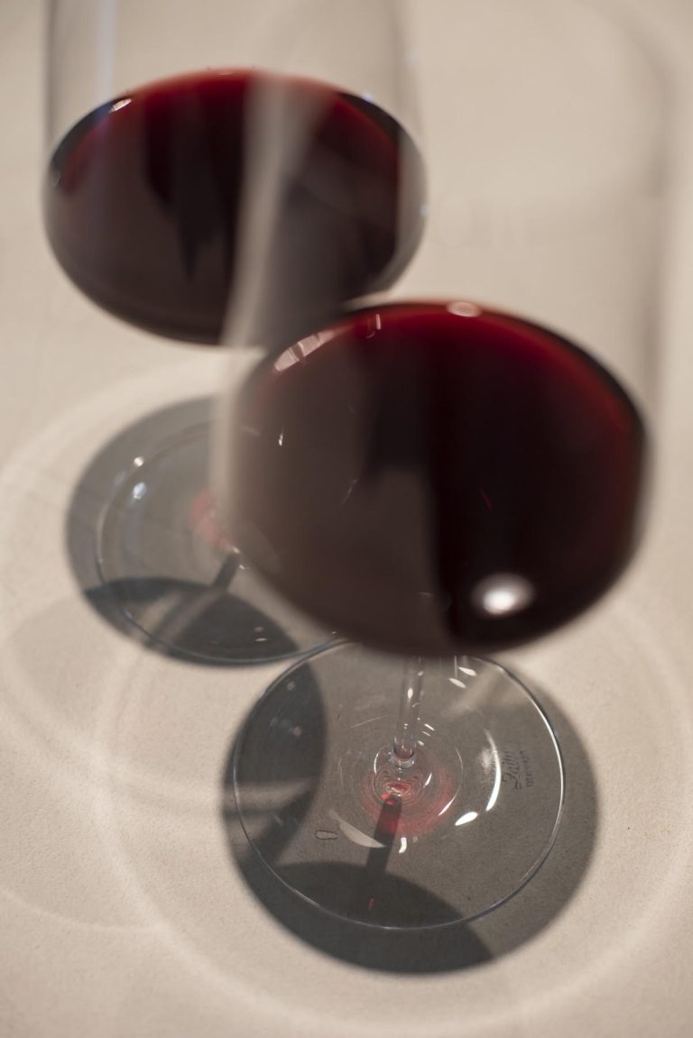 Deux verres de vin rouge en contre-plongee, sur fond clair